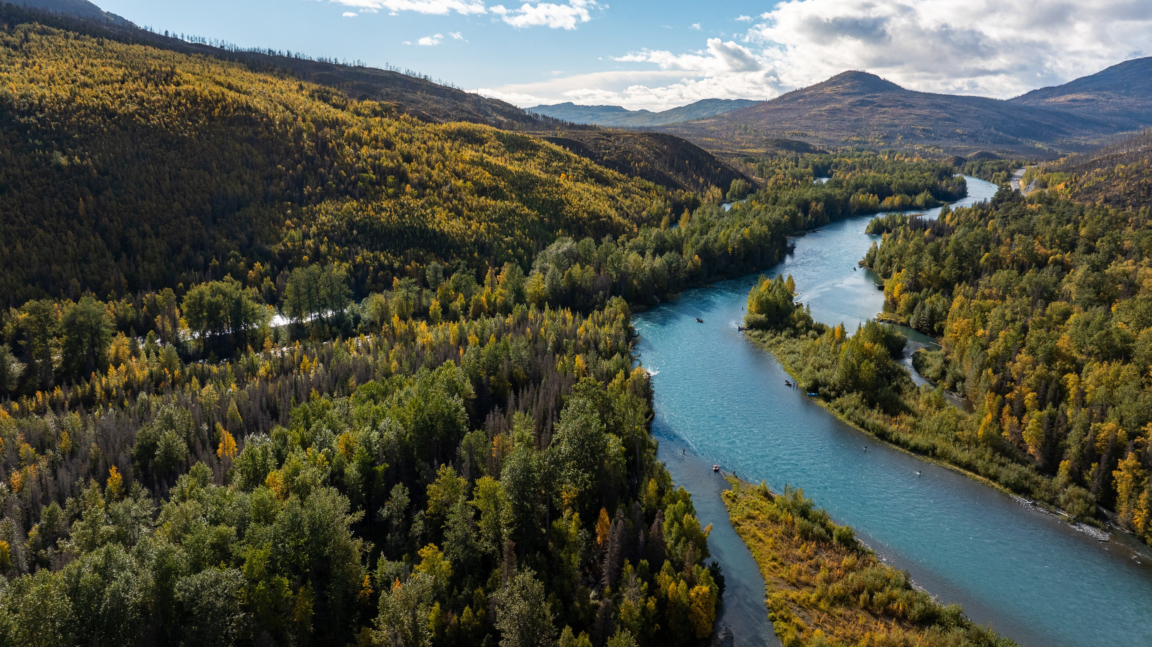 A drone photograph taken above the Kenai River overlooking fishermen on the water catching salmon during the peak Alaskan Salmon Run.